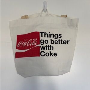 Coca-Cola White Tote with Red Logo and Black Text. 50% Recycled Poly, 50% cotton
